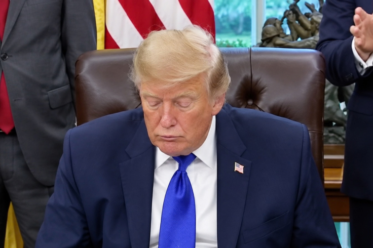 Donald Trump lower his head and close his eyes