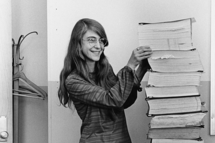 Restored photograph of Margaret Hamilton holding printed software code