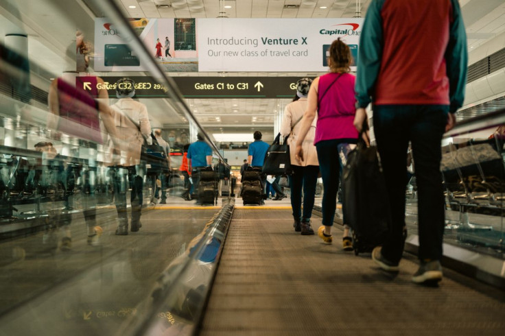 Passengers navigate a busy airport terminal