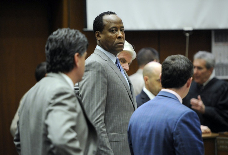 Dr. Conrad Murray stands with his attorneys in the courtroom after the defense rested its case during his trial in the death of pop star Michael Jackson in Los Angeles