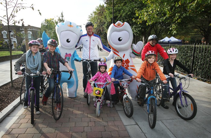 Olympian Mark Foster, the London 2012 mascots Wenlock and Mandeville and local children help launch a series of upgraded cycle and walking routes across London on Oct. 24, 2011.