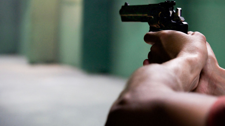 Close-up shot of hands aiming a pistol
