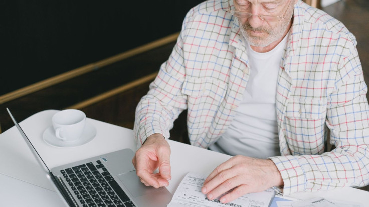 A Retiree Checking his Finances on a Laptop