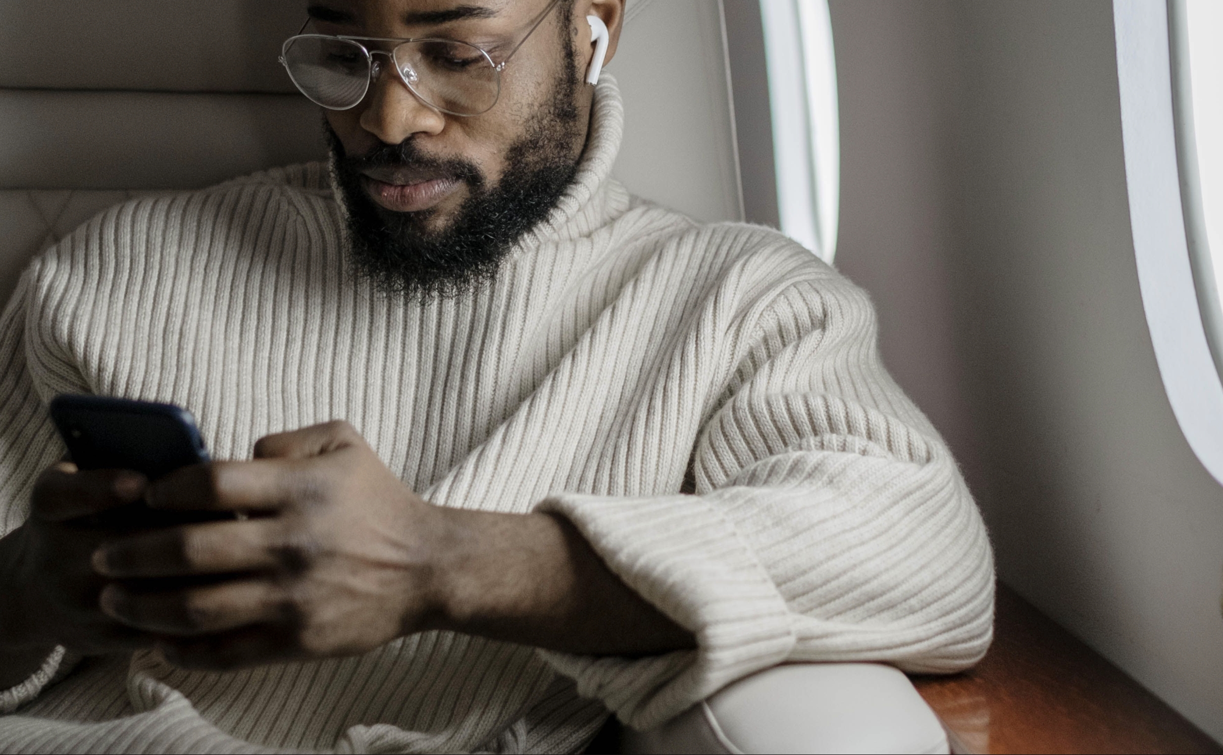 Man using phone on the plane