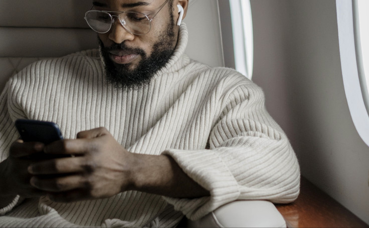 Man using phone on the plane