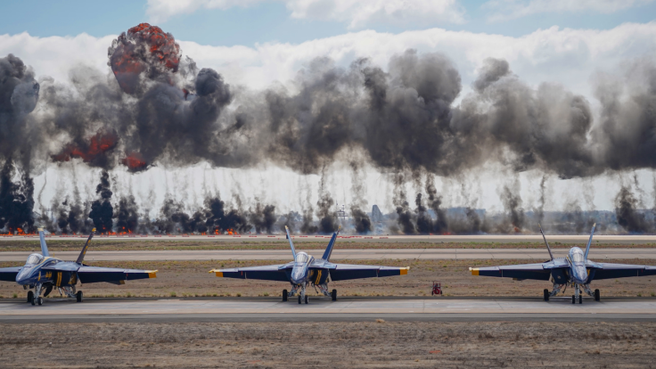 Dynamic scene featuring Blue Angels jets amid smoke