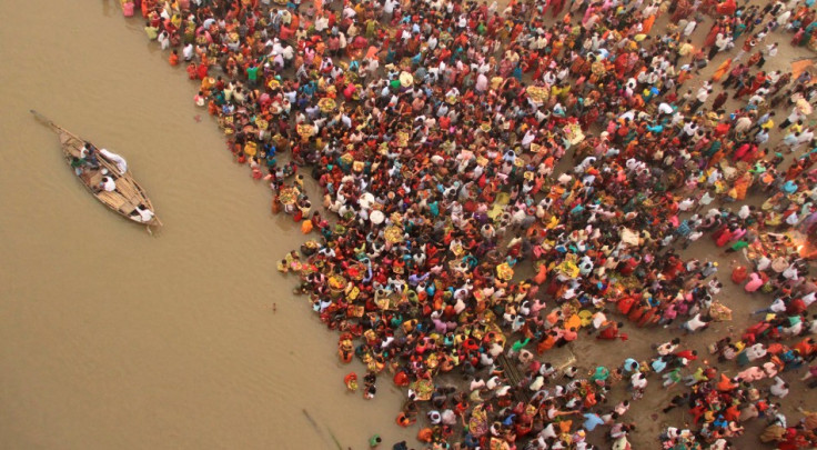 Hindu devotees gather to worship the Sun god on the banks of river Ganges during the Hindu religious festival Chhat Puja in Patna
