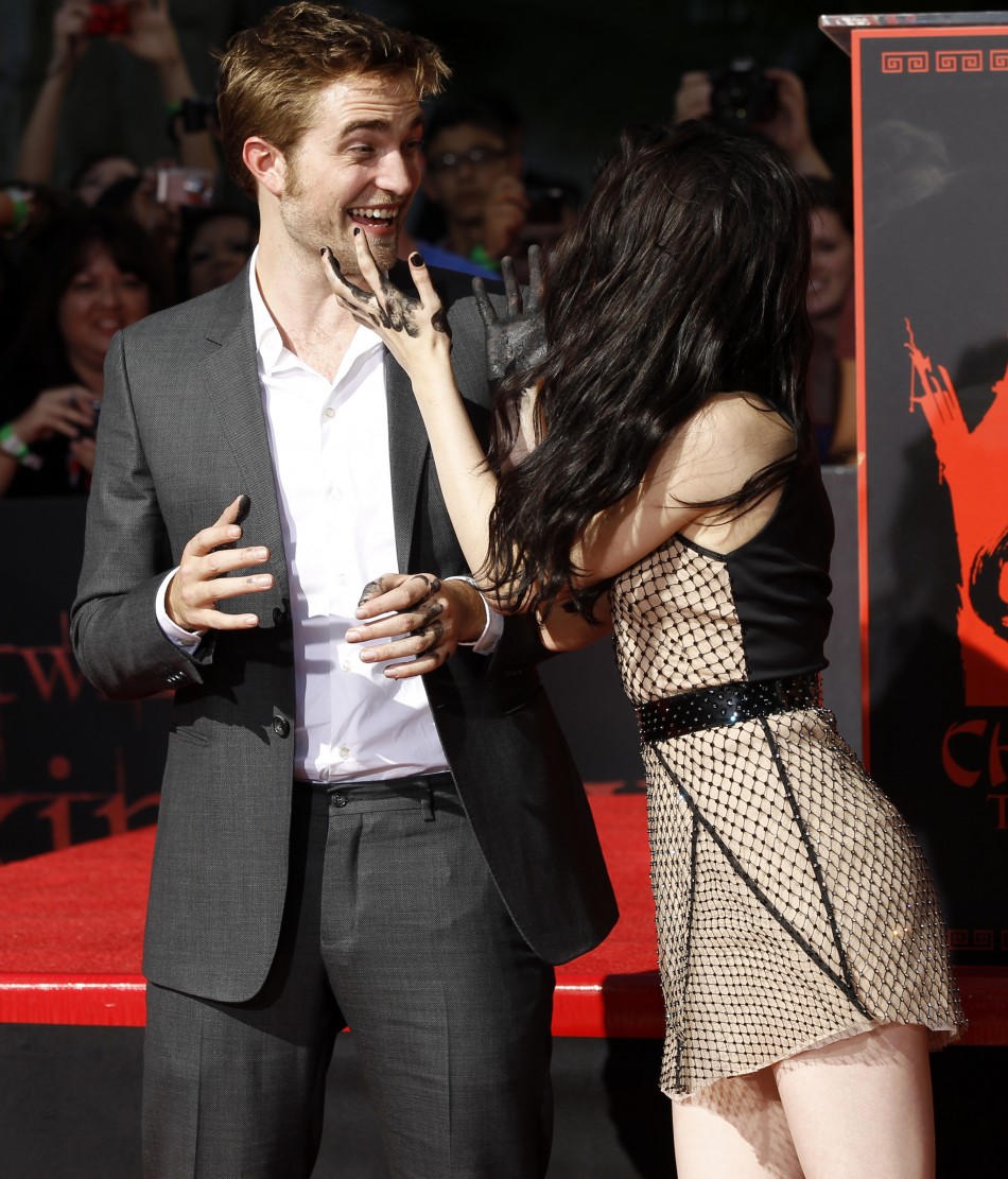 Actors Robert Pattinson and Kristen Stewart joke after leaving handprints in cement during a hand and footprint ceremony at the Grauman039s Chinese Theatre in Hollywood, California on November 3, 2011.