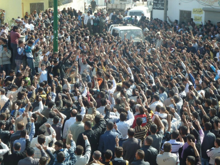 Anti-government protesters shout slogans against Syria's President Bashar al-Assad during the funeral of Sunni Muslim villagers killed on Wednesday, in Hula near Homs November 2, 2011