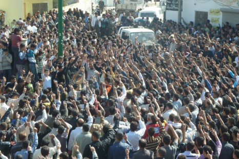 Anti-government protesters shout slogans against Syria&#039;s President Bashar al-Assad during the funeral of Sunni Muslim villagers killed on Wednesday, in Hula near Homs November 2, 2011