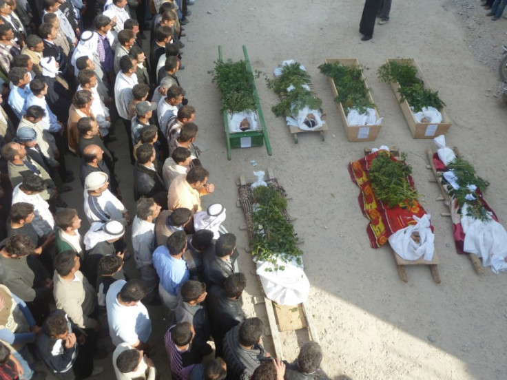 Anti-government protesters pray next to the bodies of people who were among the Sunni Muslims killed on Wednesday, in Hula near Homs November 2, 2011.