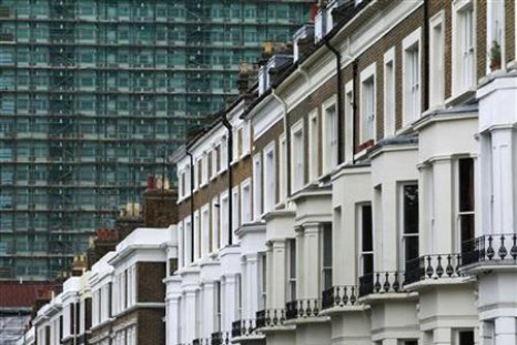 A row of terraced houses are seen below an apartment block in London