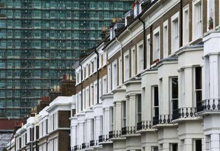 A row of terraced houses are seen below an apartment block in London