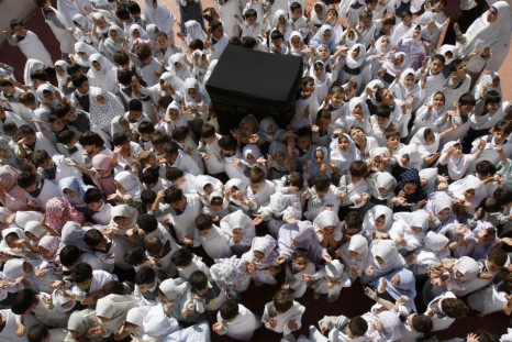 Palestinian schoolchildren simulate the annual Muslim pilgrimage of Hajj, at their school in Nablus