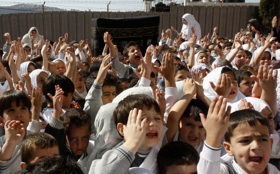 Palestinian schoolchildren simulate the annual Muslim pilgrimage of Hajj, at their school in Nablus