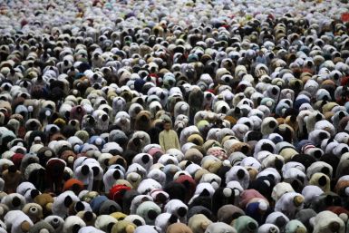 Muslims attend a prayer session along a street in celebration of the Eid al-Adha festival in Jakarta
