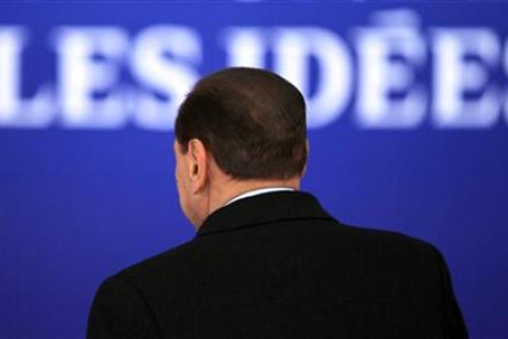 Italy's PM Berlusconi is seen from the back as he arrives for the second day of the G20 Summit in Cannes