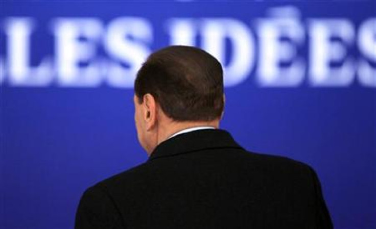 Italy's PM Berlusconi is seen from the back as he arrives for the second day of the G20 Summit in Cannes