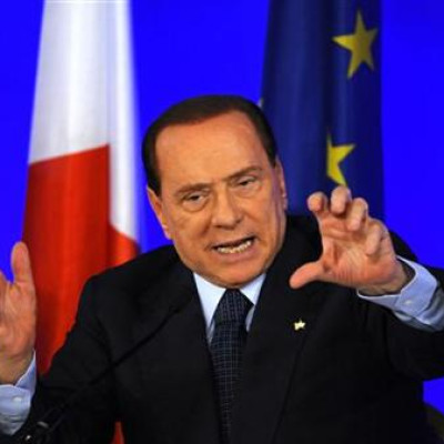 Italy&#039;s Prime Minister Berlusconi gestures during a news conference at the end of the G20 Summit in Cannes
