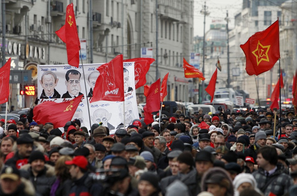 Communist supporters carry flags and banners during a march through central Moscow on Revolution Day