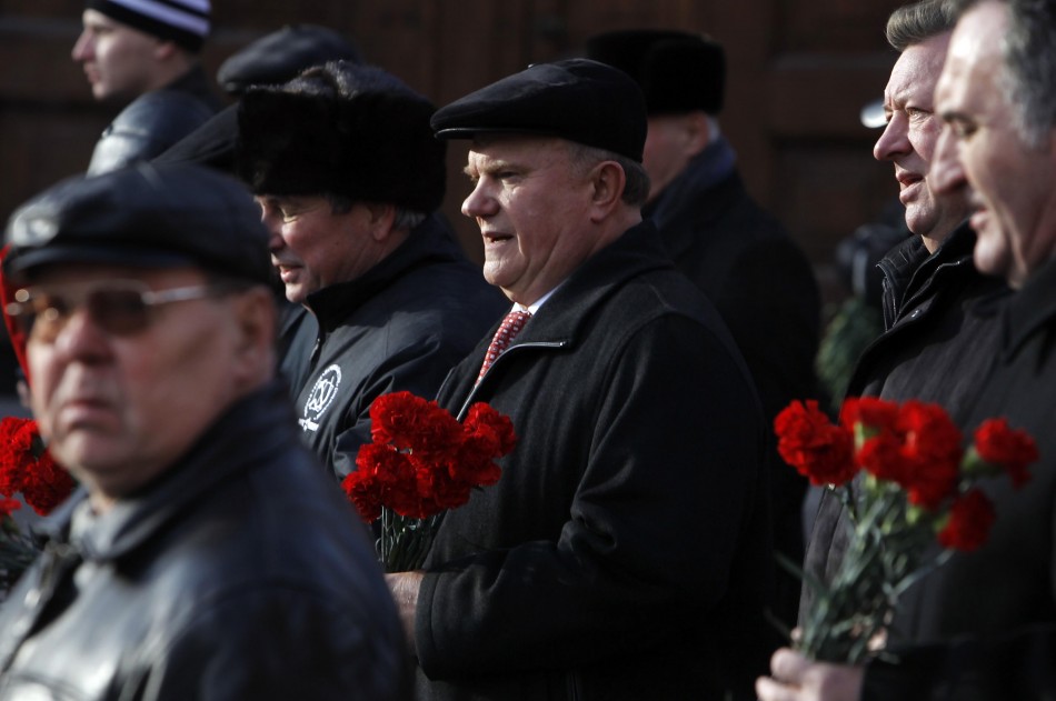 Communist leader Gennady Zuganov holds flowers to put on the graves of prominent Communists on Moscows Red Square