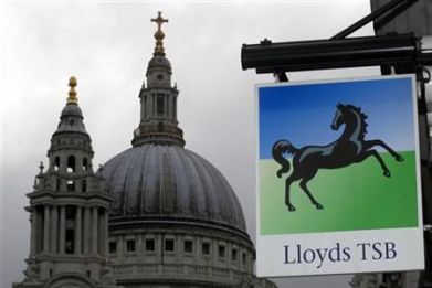 A Lloyds bank branch sign is seen near St Paul's Cathedral in the City of London
