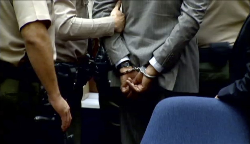 Dr. Conrad Murray is led away in handcuffs into custody of the Los Angeles Sheriffs