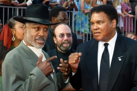 Boxers Joe Frazier (L) and Muhammad Ali pose together as they arrive at the 10th annual ESPY Awards in 2002.