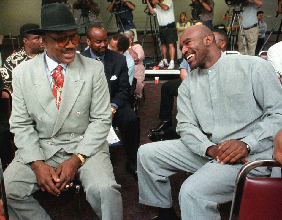 WBAIBF Heavyweight champion Evander Holyfield R chats with former heavyweight champion Joe Frazier L prior to a press conference on August 11