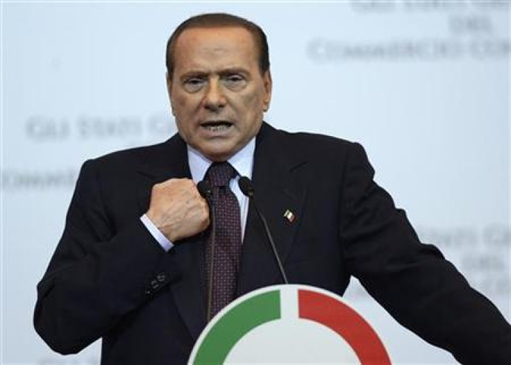 Italy Prime Minister Silvio Berlusconi gestures as he speaks during a meeting in Rome