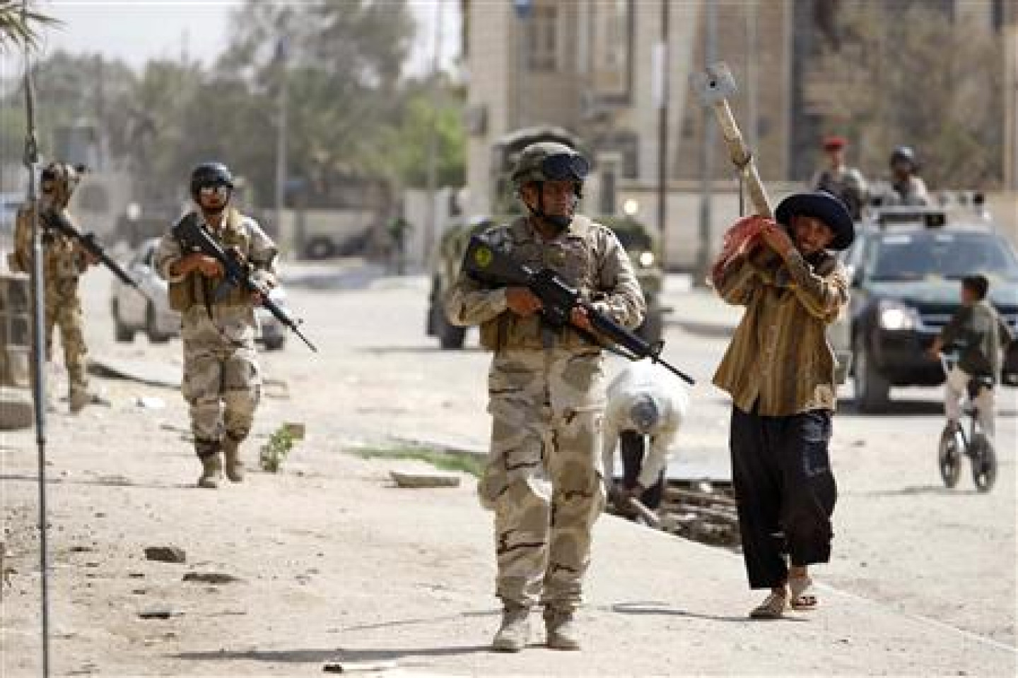 Soldiers patrol along a street during a security operation in Basra