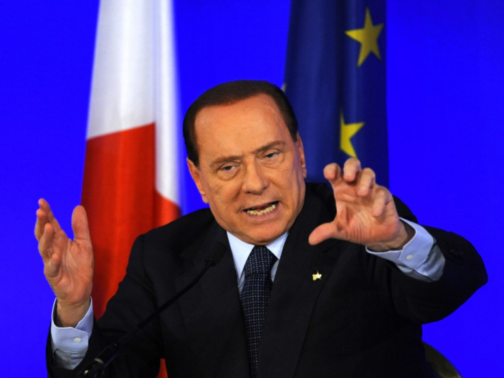 Italy's Prime Minister Berlusconi gestures during a news conference at the end of the G20 Summit in Cannes