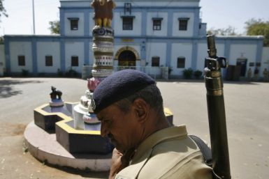 An Indian security personnel stands guard outside the Sabarmati central jail in Ahmedabad