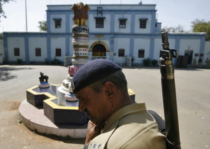 An Indian security personnel stands guard outside the Sabarmati central jail in Ahmedabad