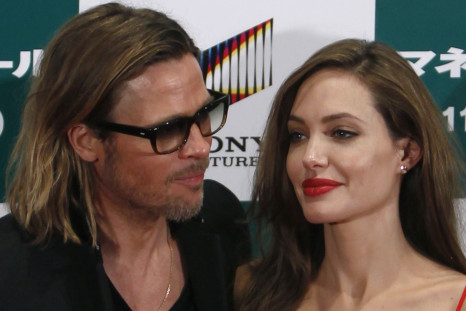 U.S. actor Brad Pitt and his partner Angelina Jolie pose during the Japan premiere of Pitt's film &quot;Moneyball&quot; in Tokyo