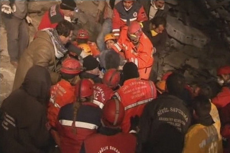 Rescuers assist earthquake survivor Konnai after earthquake south of the city of Van