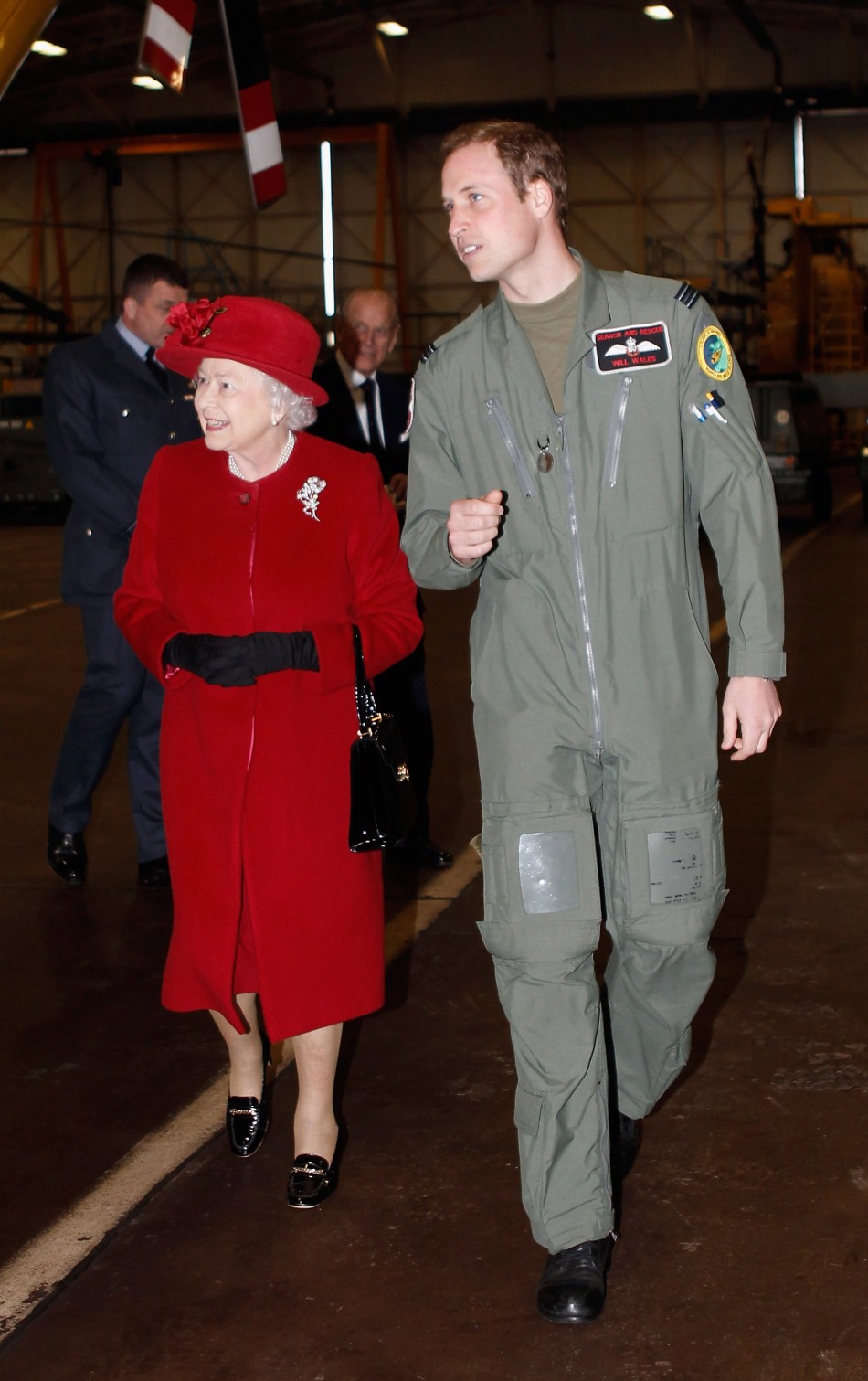 Britains Queen Elizabeth talks with her grandson Prince William after being shown around a Sea King search and rescue helicopter during a visit to RAF Valley in north Wales
