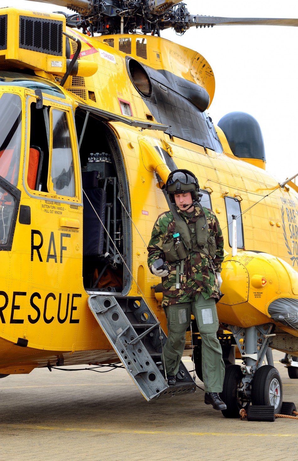 Britains Prince William disembarks a Sea King helicopter at RAF Valley on Anglesey, in Wales