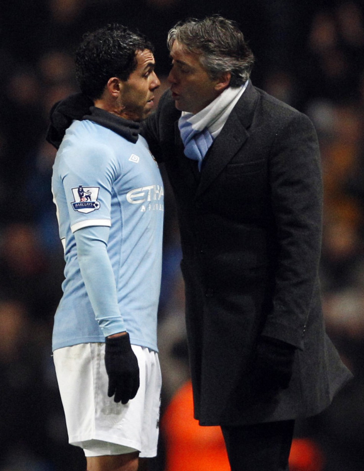 Manchester City's Tevez argues with manager Mancini after being substituted during their English Premier League soccer match against Bolton Wanderers in Manchester
