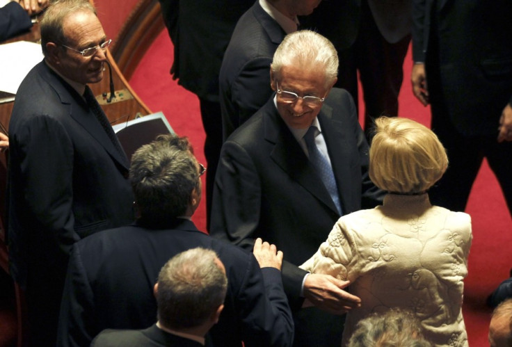 Former European Commissioner Monti is greeted by senators as he arrives at the Senate in Rome