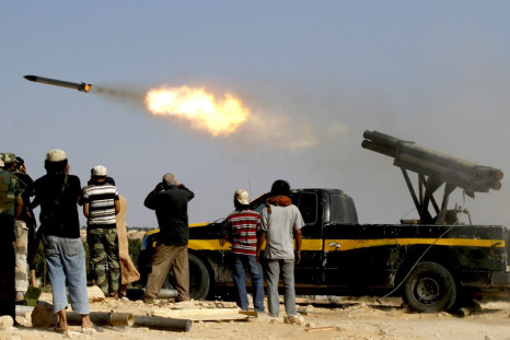 Forces loyal to Libya&#039;s interim rulers fire rockets at an area in Libya
