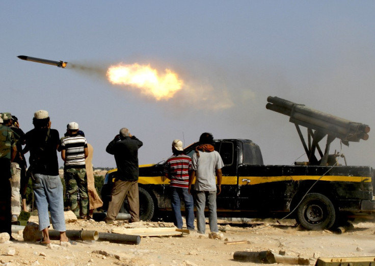 Forces loyal to Libya&#039;s interim rulers fire rockets at an area in Libya