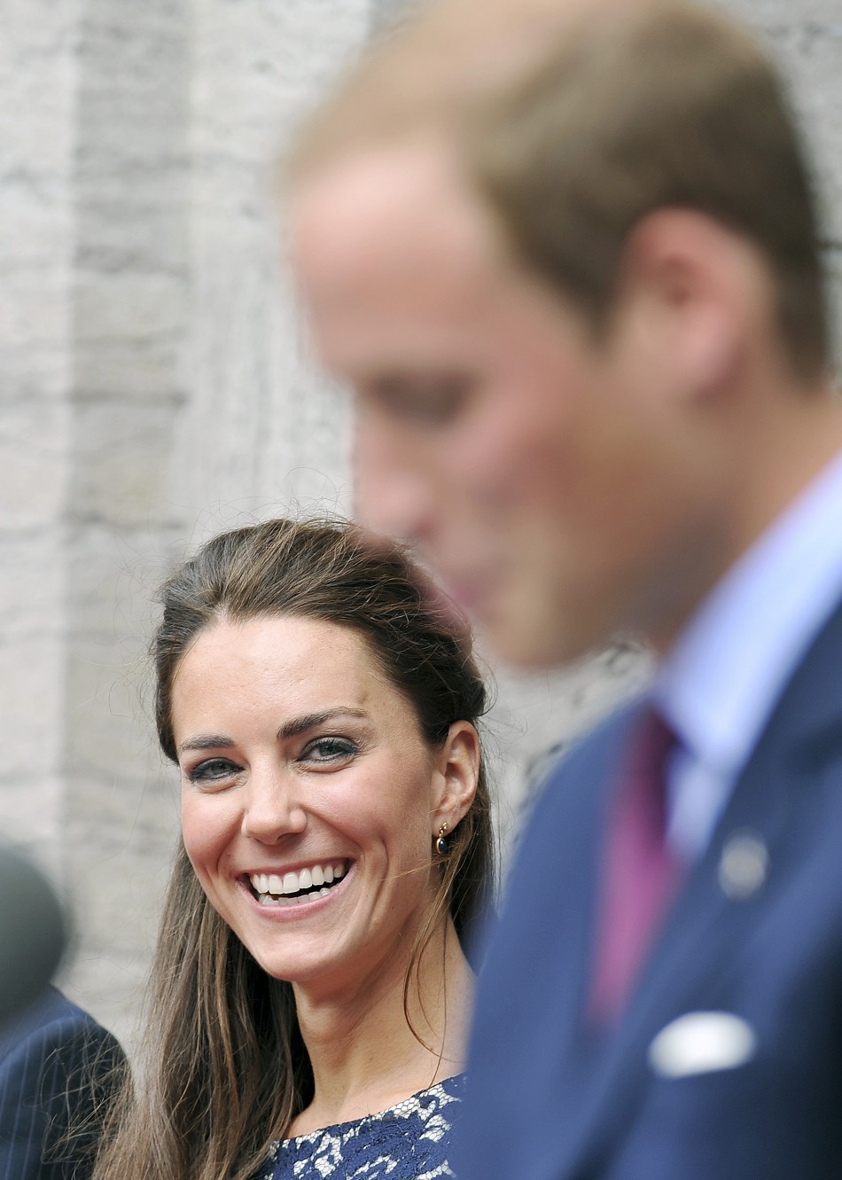 Britains Catherine, Duchess of Cambridge laughs as her husband Prince William speaks outside the official residence of the Governor General of Canada, Rideau Hall in Ottawa