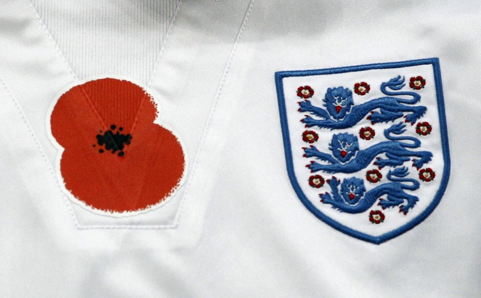 A remembrance day poppy is seen on the training top of Englands Scott Parker before his international friendly soccer match against Spain in London