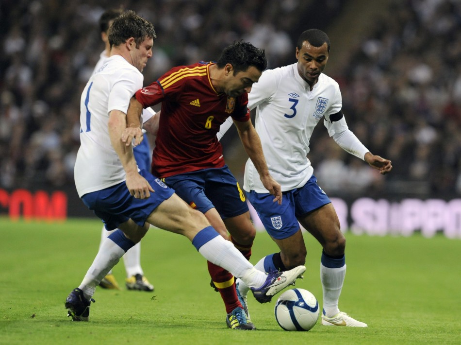 Englands Milner and Cole challenge Spains Xavi during their international friendly soccer match in London