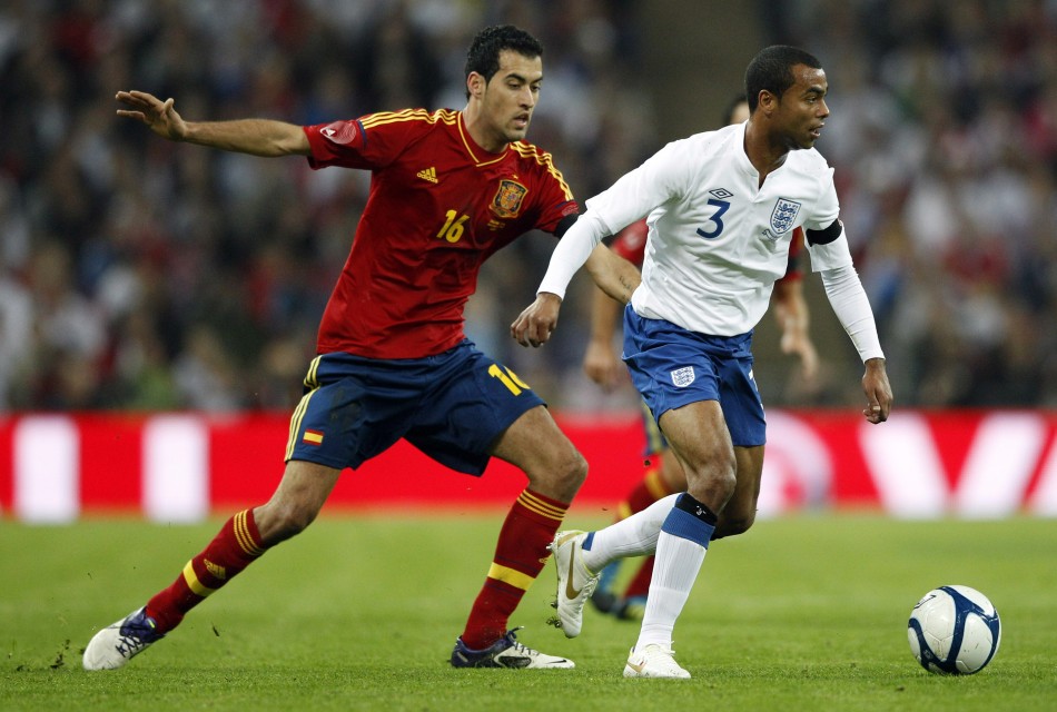 Englands Cole and Spains Busquets challenge for the ball during their international friendly soccer match at Wembley Stadium in London