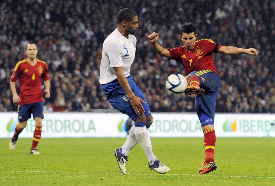 Spains Villa shoots past Englands Johnson during their international friendly soccer match in London
