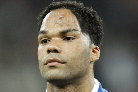England's Joleon Lescott lines up for the national anthems before their international friendly soccer match against Spain at Wembley