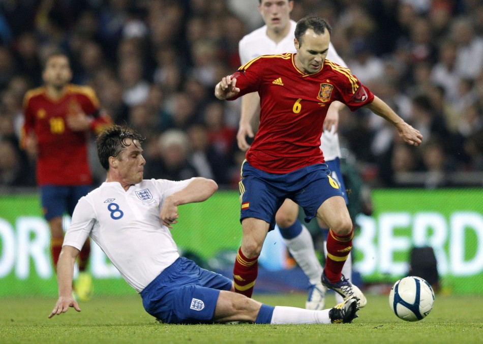 Spains Iniesta is tackled by Englands Parker during their international friendly soccer match at Wembley Stadium in London