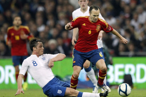 Spain's Iniesta is tackled by England's Parker during their international friendly soccer match at Wembley Stadium in London